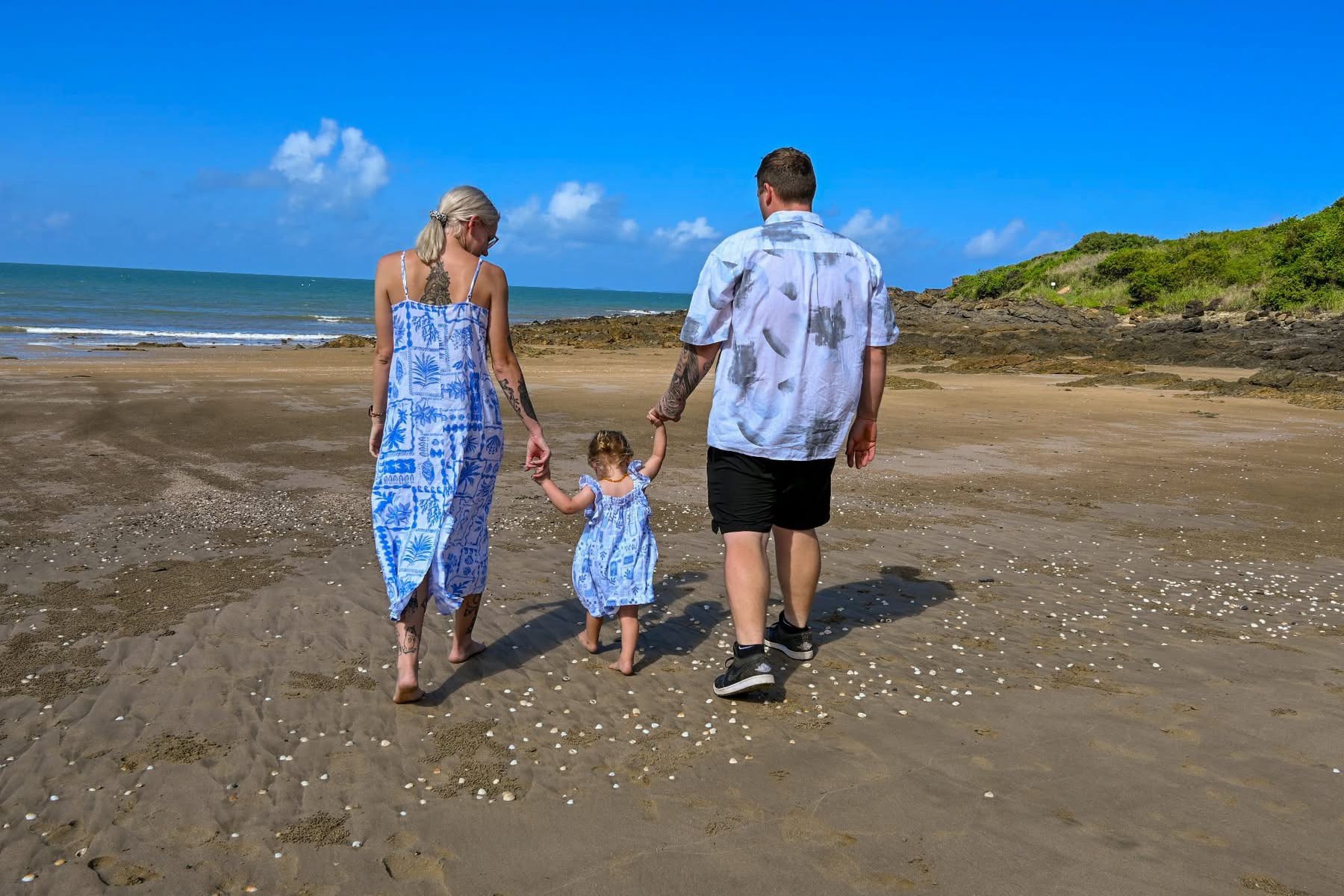 Family walking towards the ocean