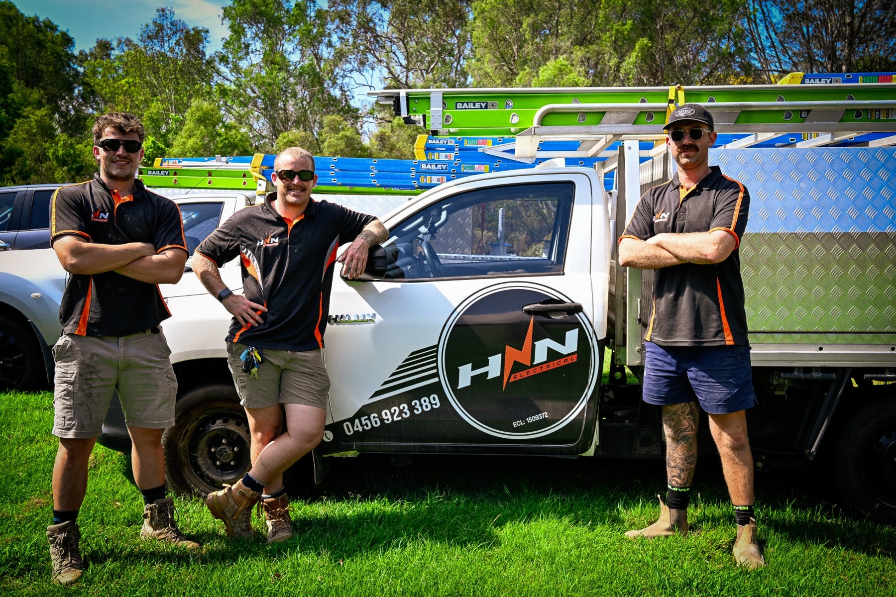 HNN Electrical team standing beside their company ute