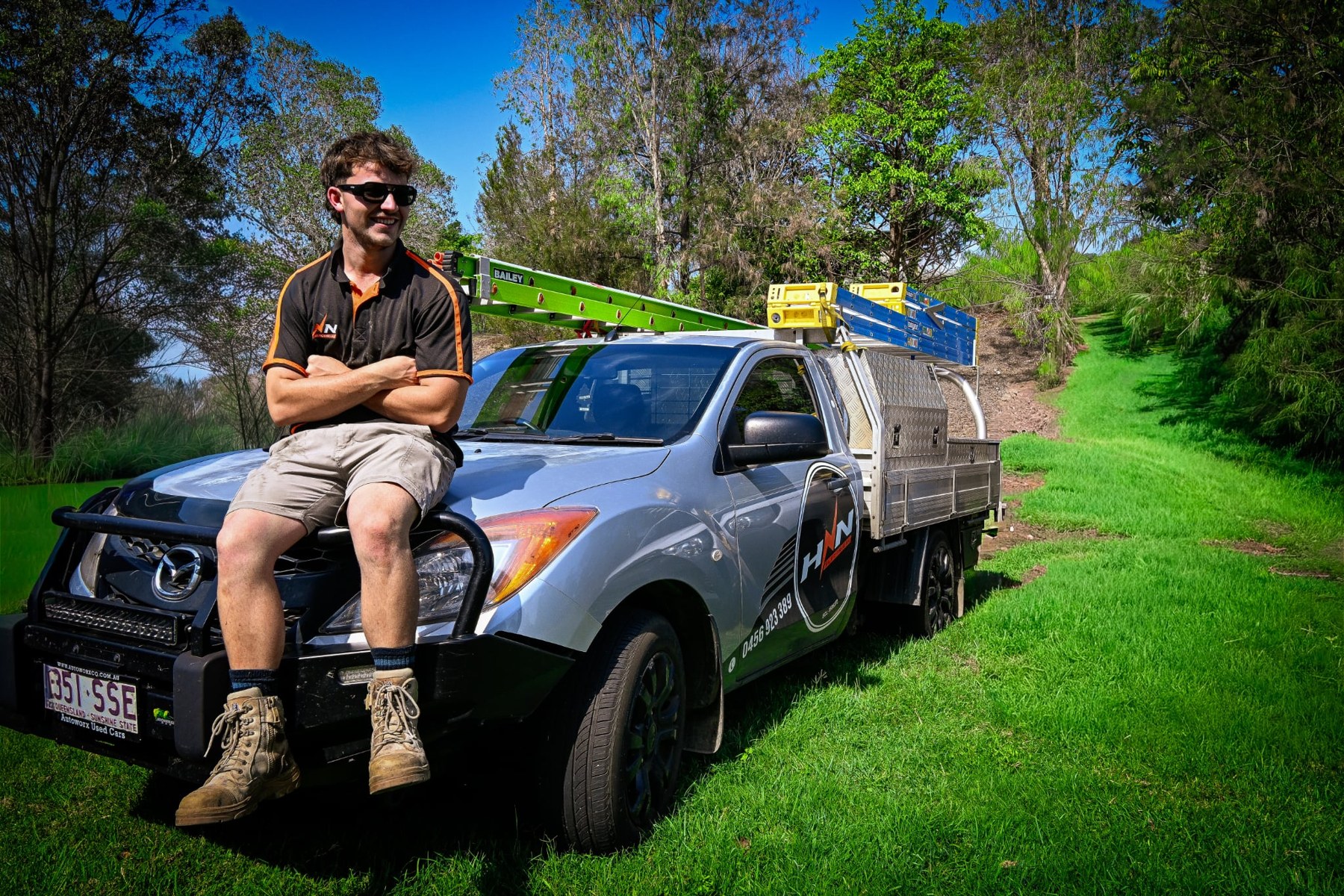 HNN Electrical employee seated on a company vehicle